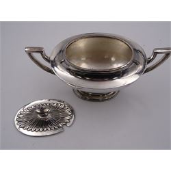 Edwardian twin handled sucrier, of plain oval form, the lid with embossed sugar cane leaves and urn shaped finial, upon conforming stepped foot, hallmarked Birmingham 1901, maker's mark worn and indistinct