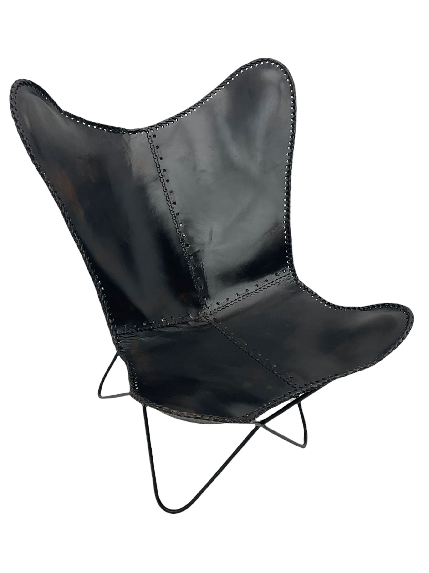 Metal framed butterfly chair upholstered in slung dark tan stitched leather 
