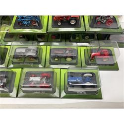 Eighteen issues of Tractors and The World of Farming magazine, together with sixty diecast tractors, all in original packaging, in three boxes 