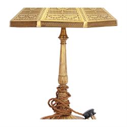 In the manner of Tiffany & Co, early 20th century gilt bronze Adam pattern table lamp, circa 1910, the circular spreading base decorated with flower heads and beaded bands, stiff leaves and husks, leading to a reeded column detailed with stiff leaves and swags, supporting a pierced octagonal shade, with original fittings, stamped beneath Tiffany Studios New York 539, overall H44.5cm


