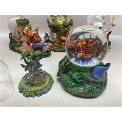 Five Disney Winnie The Pooh snow globes to include The Rain Rain Rain Came Down Down Down, Eeyore Pulling Cart, Owl's House, Rumbly in My Tumbly and Stuck In Rabbit's House, together with figure group with dome, five with boxes (6)