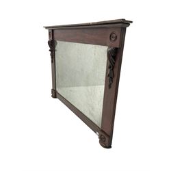 Early 20th century mahogany overmantle mirror, carved with roundels and scrolled moulding, on compressed bun feet