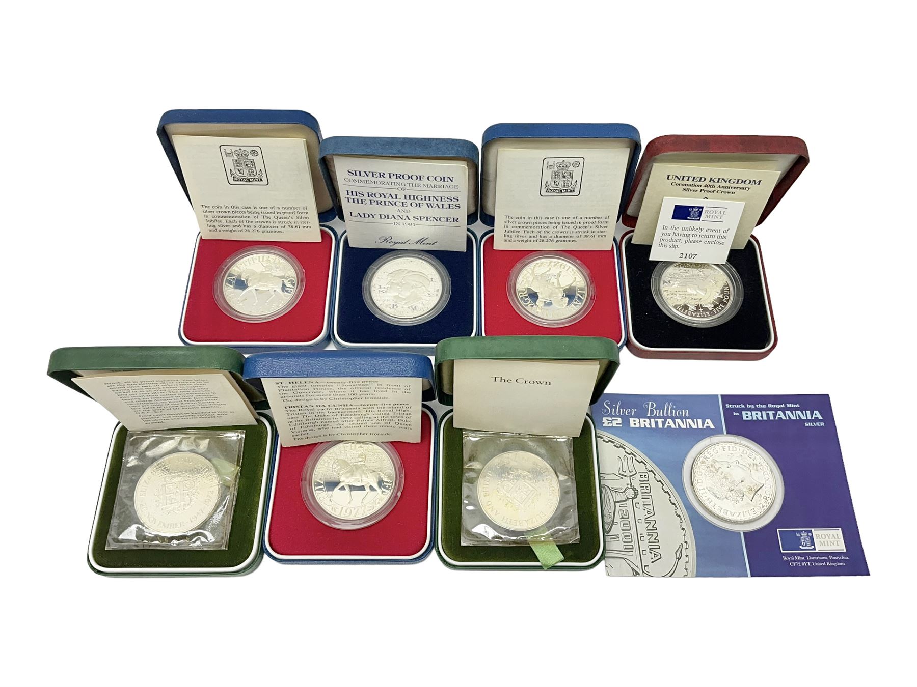 Seven The Royal Mint United Kingdom sterling silver proof crown coins, comprising two 1972, three 1977, 1981 and 1993, all cased with certificates and a Queen Elizabeth II 2001 one ounce fine silver Britannia coin on card (8)