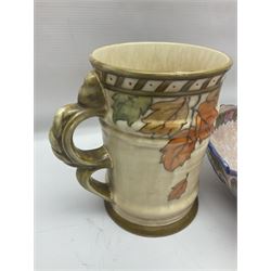 Charlotte Rhead for Crown Ducal ceramics, comprising coffin shaped vase depicting a woman in 1920s dress, a vase with handle, decorated with autumn leaves and a bowl, decorated with flowers and berries, with printed and signed marks beneath, coffin vase H24cm