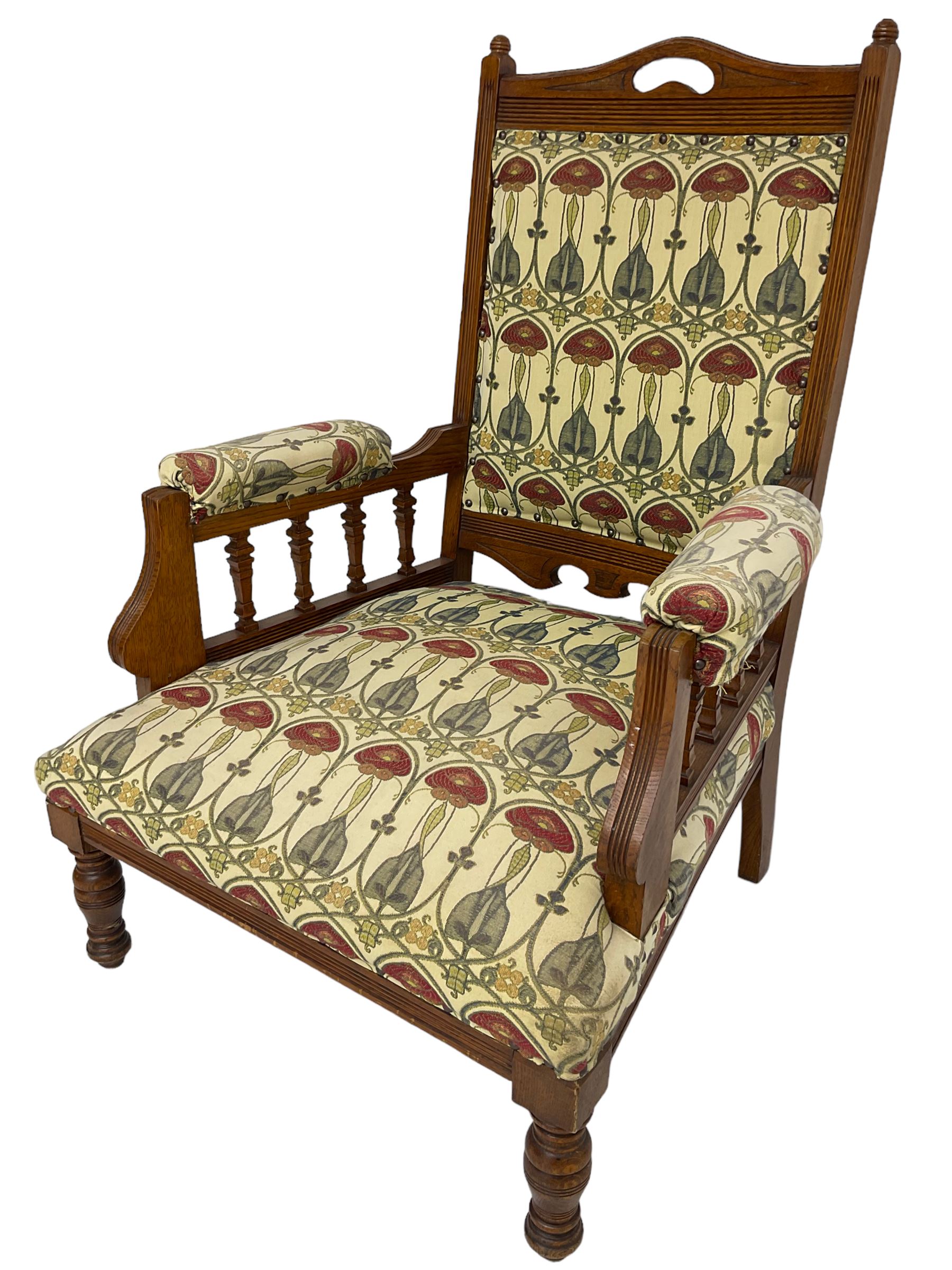 Early 20th century armchair, back and sprung seat upholstered in Art Nouveau patterned fabric, raised on ring turned supports, the frame with all-over reeded decoration
