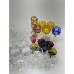 A group of assorted glassware, to include various Bohemian and other coloured glass, including five flashed and cut hock glasses, a yellow flashed vase, and smaller example, pair of Royal Brierley green glass rummers, plus a selection of clear glass drinking glasses of various form, including a number of sets and examples marked Stuart and a small number marked Waterford. 