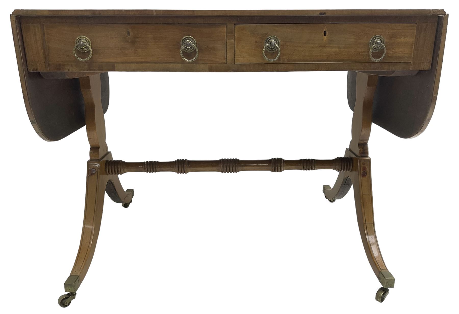 Regency mahogany sofa table, rectangular crossbanded top with twin drop-leaf ends, fitted with single drawer and one faux drawer, raised on shaped end supports united by ring turned stretcher