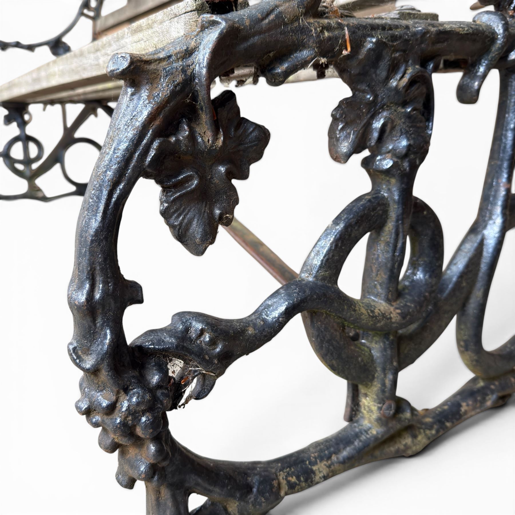 Victorian revival Coalbrookdale 'Dog and Serpent' pattern heavy cast iron garden bench, grape vine detail, joined with eight hardwood slats, finished in black paint