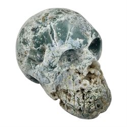 Carving of a skull in moss agate, H9cm, L12cm 