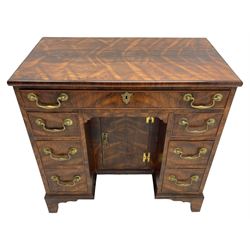 George III design rosewood kneehole desk, rectangular top with moulded edge, fitted with single frieze drawer and six graduating mahogany lined short drawers, each with cock-beaded facias, the central recessed cupboard enclosing single shelf, lower moulded edge over shaped bracket feet, stamped 'G Burton' to inner drawer