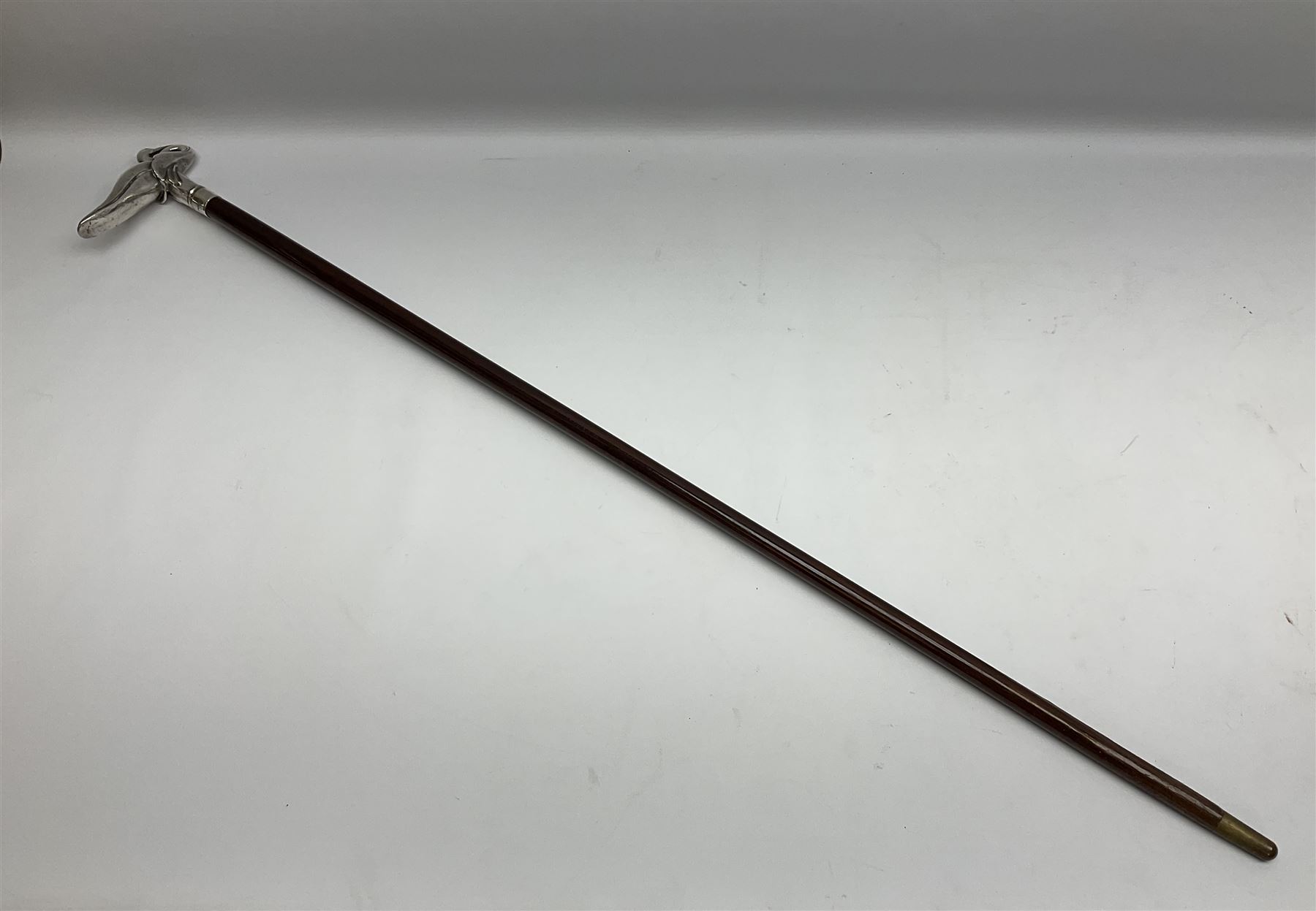 Art Deco style Italian 'Rivestito' covered silver walking stick handle, modelled in the form of a swan, stamped 'R', upon a silver collar hallmarked Birmingham 1986, makers mark DH-L, and hardwood shaft, L96cm

Provenance by vendor repute: 
This walking cane comes from a private collection amassed by the current vendors mother who was an Antique dealer specialising in walking sticks, working at the Portobello Road Antique Market in London for over forty years. 
In 1988 the prop crew from LWT (now ITV) visited Portobello Road looking for, amongst other items, a signature stick for David Suchet to use in his portrayal of Agatha Christie's Poirot. 
At the time this particular walking stick was one of five in possession. The prop crew chose and purchased another of the five which was then used by Suchet throughout all seventy episodes of the much loved series. 
Following the conclusion of the series Suchet was gifted his particular cane, which has been loaned to and can now be seen at the Agatha Christie Gallery at the Torquay Museum. 
