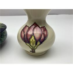 Moorcroft dish and cover, of circular form, decorated in Buttercup pattern, together with a Moorcroft vase, of baluster form, decorated in Magnolia pattern, both with printed marks beneath, tallest H9.5cm
