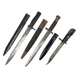 British No 7 MKI knife bayonet with 20cm single edged fullered clipped point blade;  blackened steel, large muzzle ring cross-guard; blackened swivelling pommel marked 'F5H'; red Tufnol composite grips; in blackened steel scabbard L33cm overall; British Pattern 1888 bayonet with scabbard; and German Ersatz bayonet with scabbard (3)