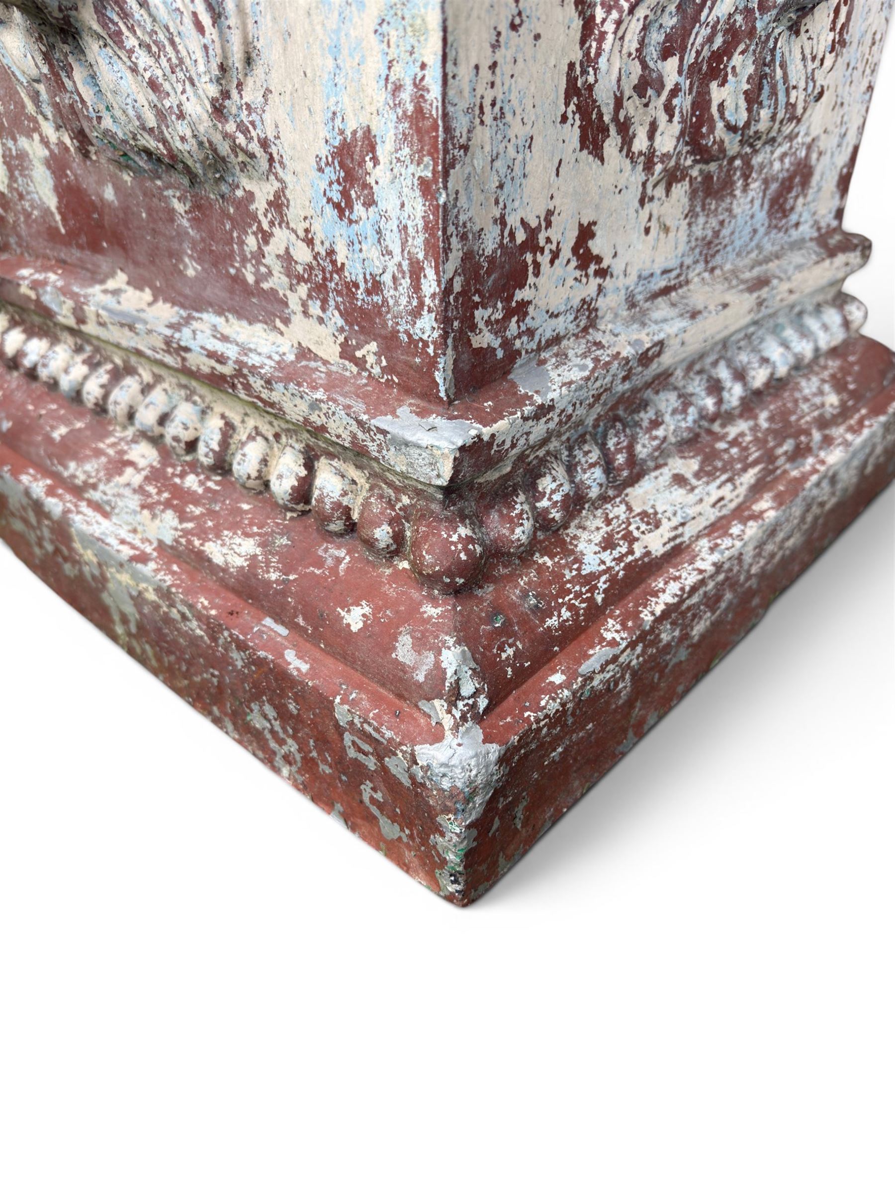 Early 20th century terracotta pedestal, square form with egg and dart detail, four lions masks to either side, finished in distressed cream paint