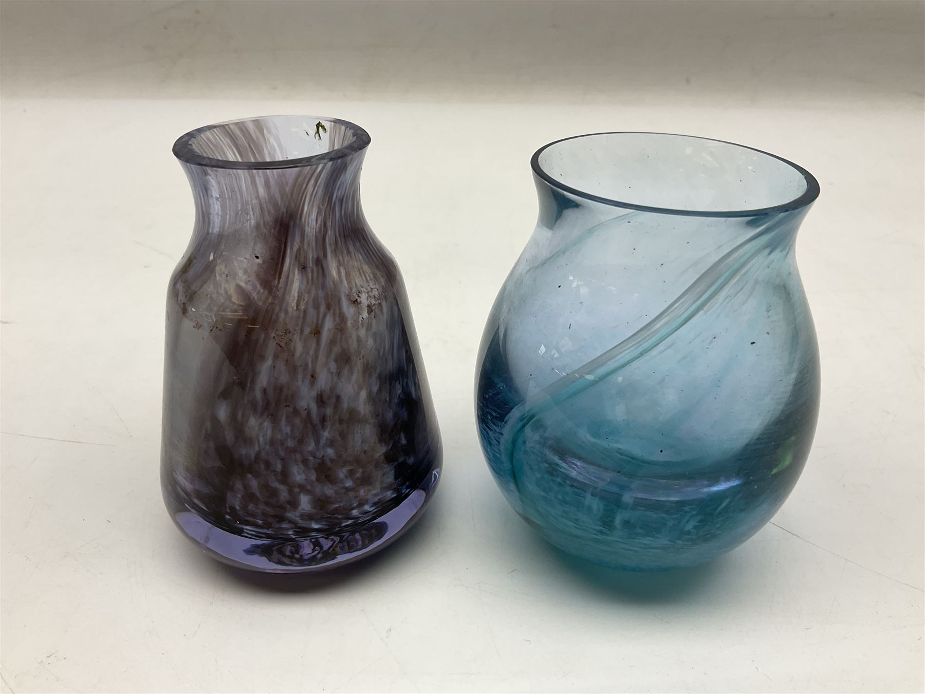 Three millefiori paperweights, together with a green glass dump paperweight with air bubble inclusions, Caithness Daisy and Cauldron paperweights and two small Caithness glass vases, tallest H9cm