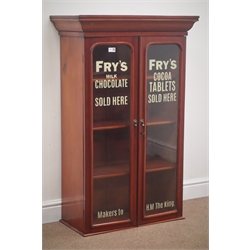  Early 20th century mahogany display cabinet, projecting cornice, two arched glazed doors with 'FRY'S MILK CHOCOLATE' painted on, enclosing three adjustable shelves, W72cm, H113cm, D36cm  