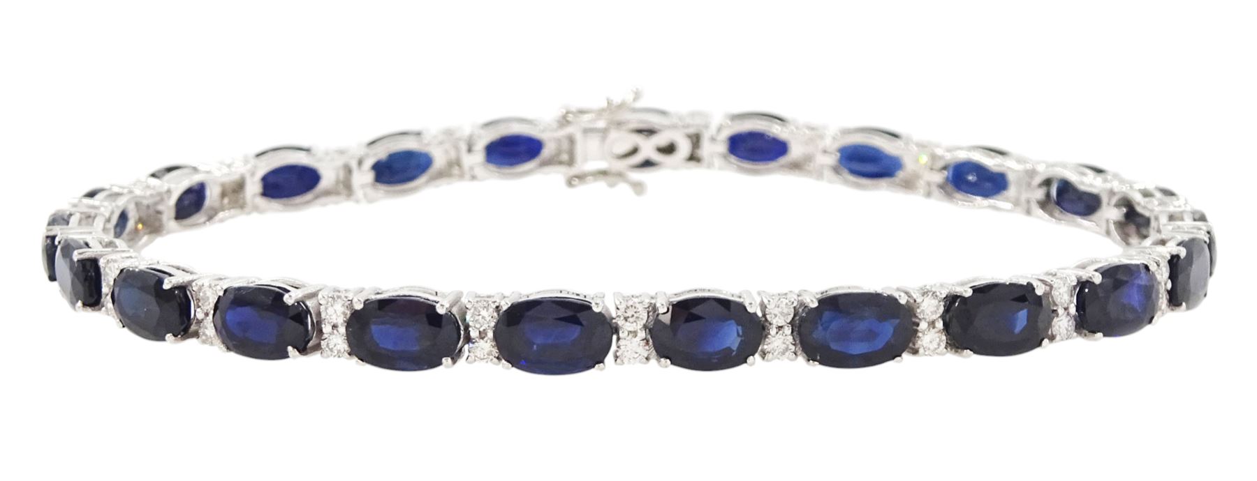 18ct white gold sapphire and diamond bracelet, twenty-three oval cut sapphires, each spaced by two round brilliant cut diamonds, stamped 750, total sapphire weight 14.785 carat, total diamond weight 0.88 carat