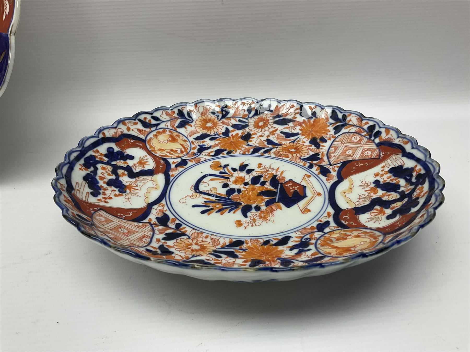 Three Japanese Imari chargers with scalloped edges, largest D38cm