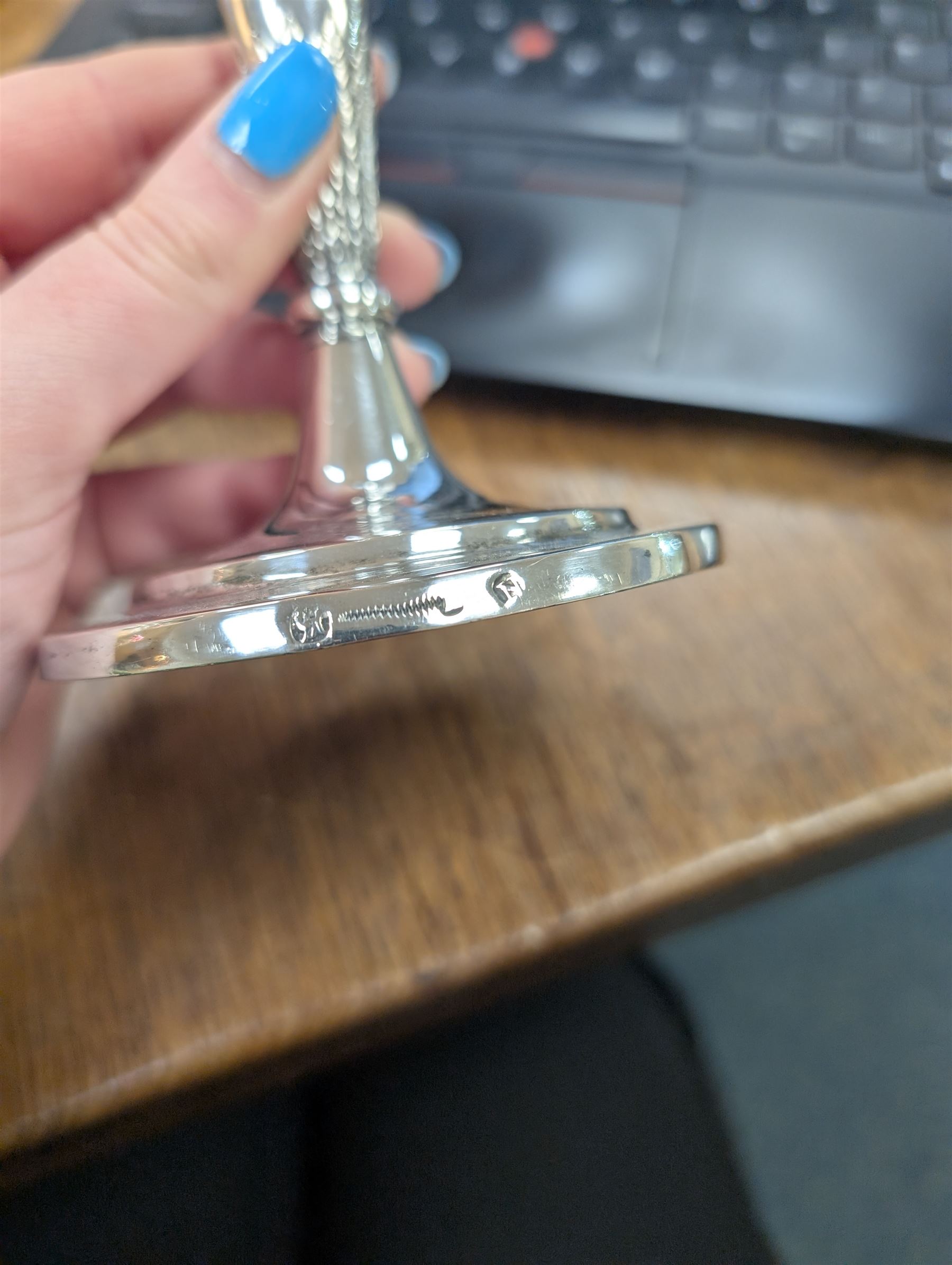 Pair of continental silver candlesticks, probably German Hanau, each of tapering form, with fern leaf decoration, upon a stepped circular base, with Hanau marks and assay scrape to base, H19cm