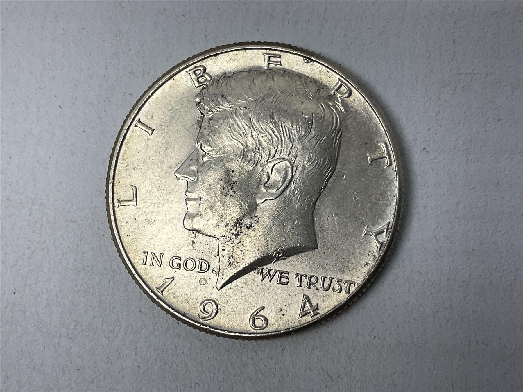 Kennedy 1964 silver half dollar, together with other American coins, bronzed figure of a young boy water carrier with yoke and brass pails, Green man wall mounted head, carved wood fish and Venetian masks etc