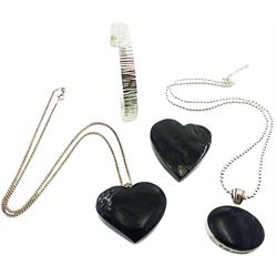 Silver Whitby jet oval pendant necklace, two silver Whitby jet heart pendants and a textured silver bangle, all stamped or tested