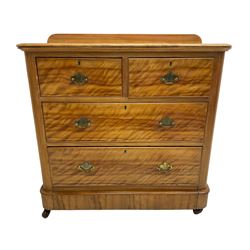 Victorian satin walnut chest, raised back over two short and two long drawers, skirted base with castors