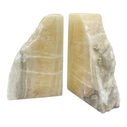 Pair of honey onyx bookends of rectangular form with polished to three sides with a raw outer edge, H18cm 