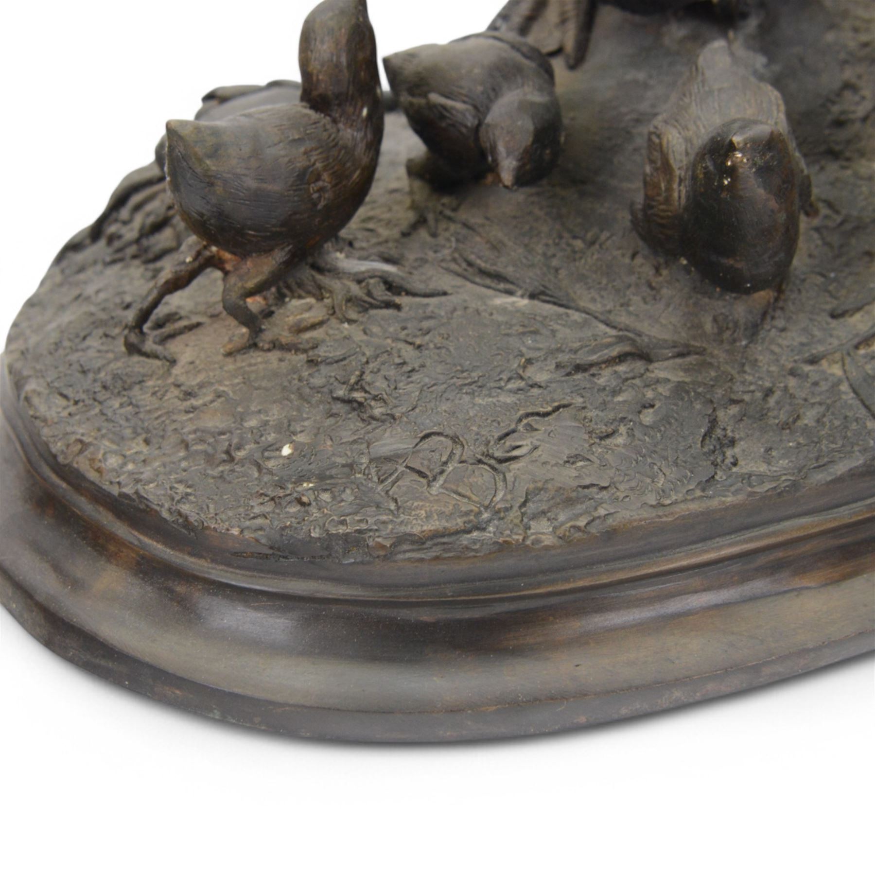 Bronzed figure group of a pheasant with six chicks upon a naturalistically modelled ground, after A. Arson, H45cm