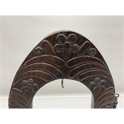 Chinese brass temple bell, decorated in high relief with a a dragon chasing a flaming pearl, within a carved floral hardwood stand, H36cm