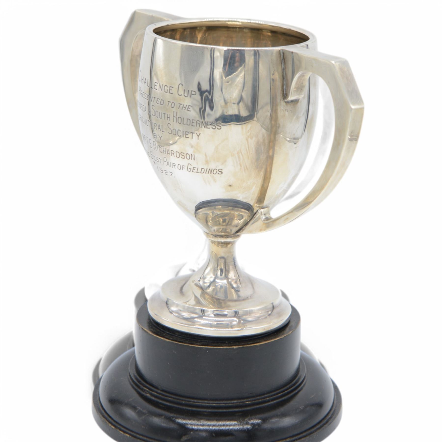 1920s silver twin handled trophy with engraving to body, upon circular foot and ebonised wooden plinth, total height H20cm
