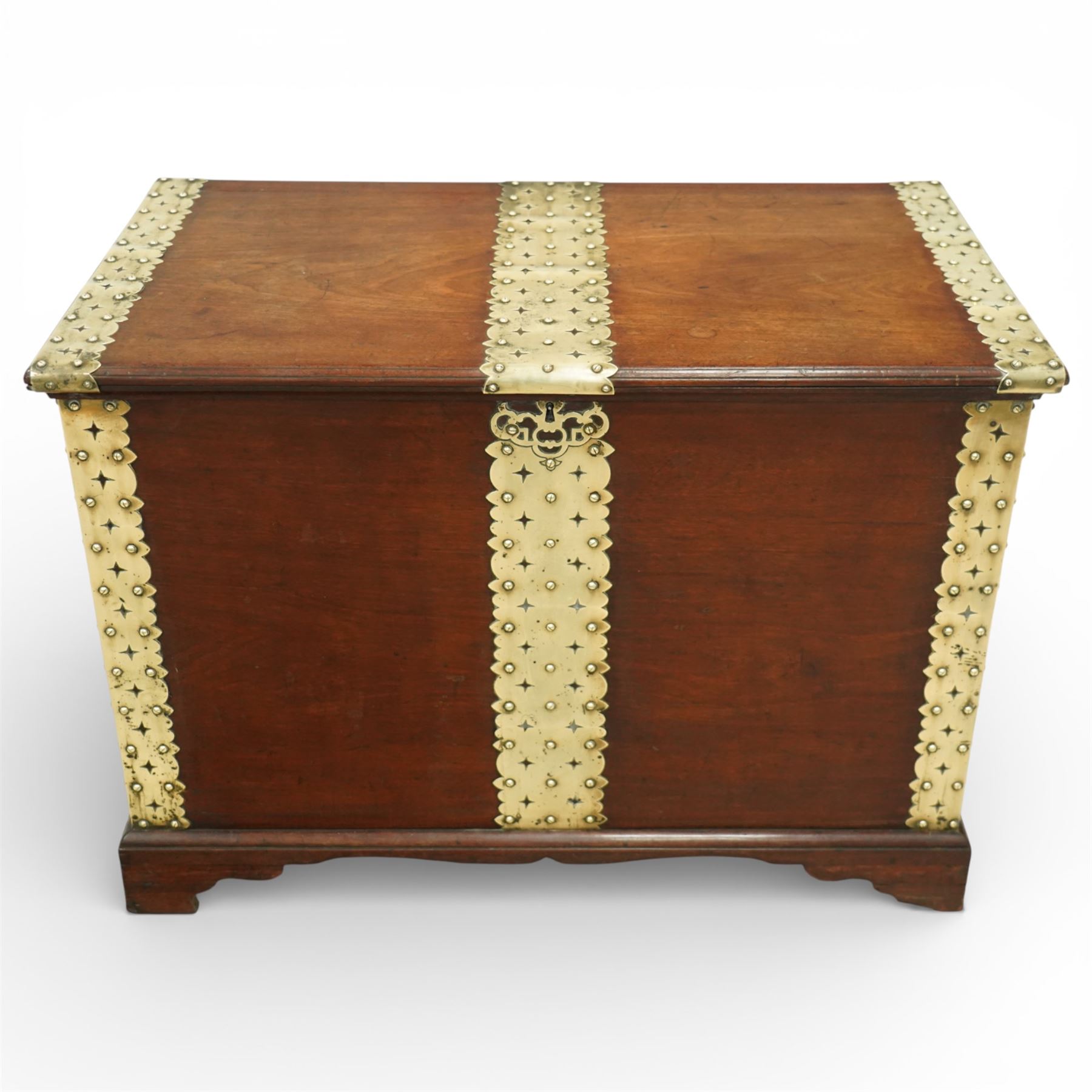 Georgian mahogany brass bound plate chest, the rectangular hinged top mounted with pierced and studded brass straps, fitted with pierced brass escutcheon and large brass handles to the side, lower moulded edge on bracket feet