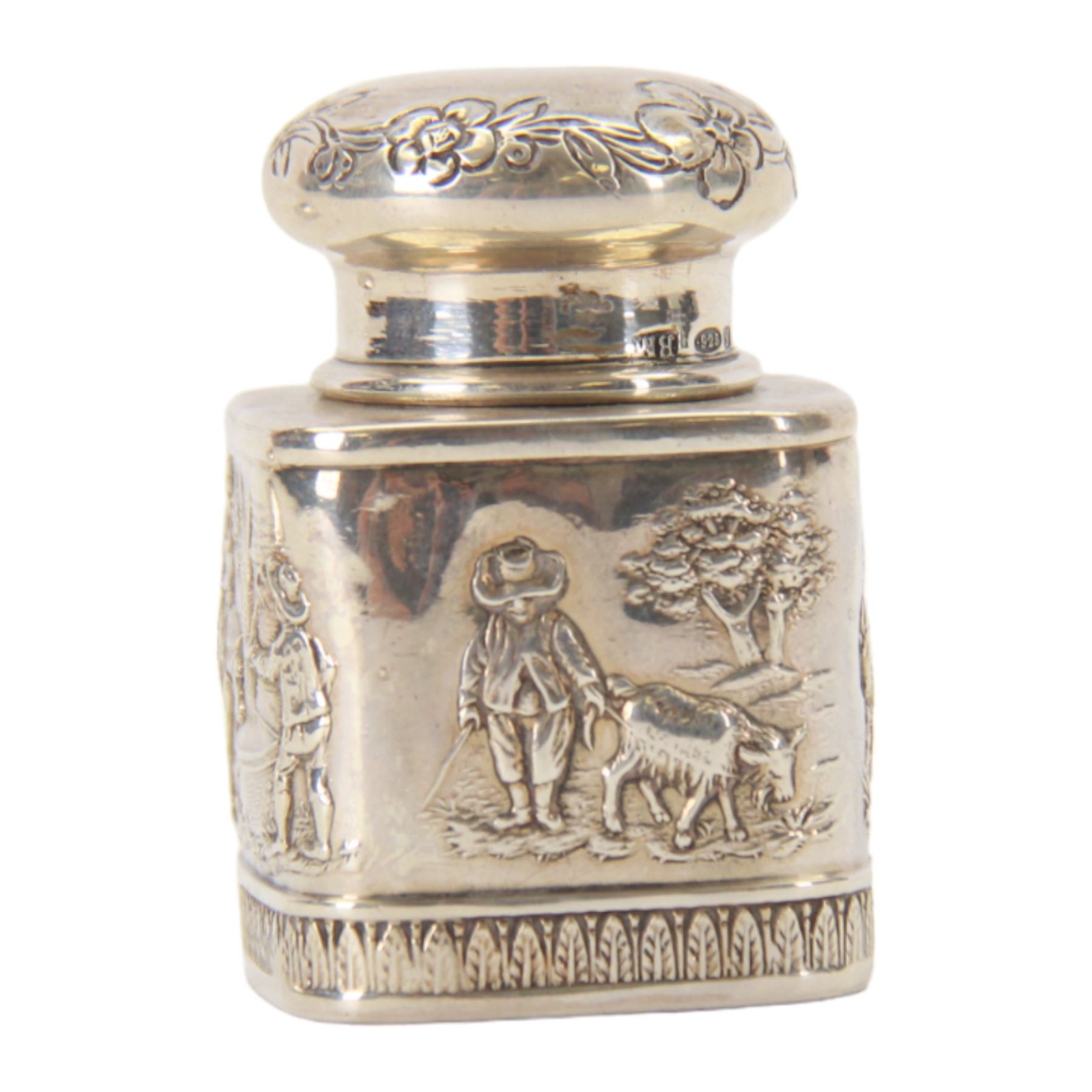 Late 19th century German Hanau silver miniature novelty scuttle, of cylindrical form with side handle and swing handle, the body impressed with figural genre scene, with Hanau marks for Karl Kurz, and hallmarked Samuel Boyce, Chester 1902, with 'F' foreign import mark, not including handle H3.5cm, together with a late 19th century German Hanau silver miniature novelty tea caddy, of rounded cube form, the body impressed with figures at work in a countryside setting, with Hanau marks for Neresheimer & Sohne, and hallmarked B Muller & Son, Chester import 1907, and marked 925, H5cm