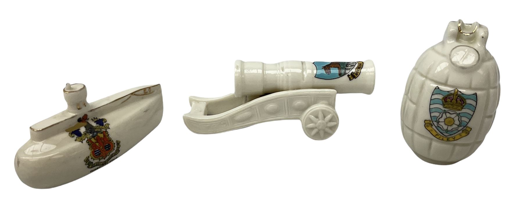 Three pieces of crested ware, comprising grenade detailed 'The Mills Hand Grenade' with Filey Crest, marked beneath Grafton China, a cannon with crest banner detailed 'Sterlini Oppidvm', marked beneath W H Goss, and a submarine with Tunbridge Wells crest, marked beneath Arcadian China 