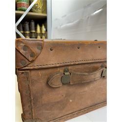Early 20th century leather trunk, with brass fixtures, leather straps and buckle fastenings, embossed to the top with initials GG, H28cm, W76cm