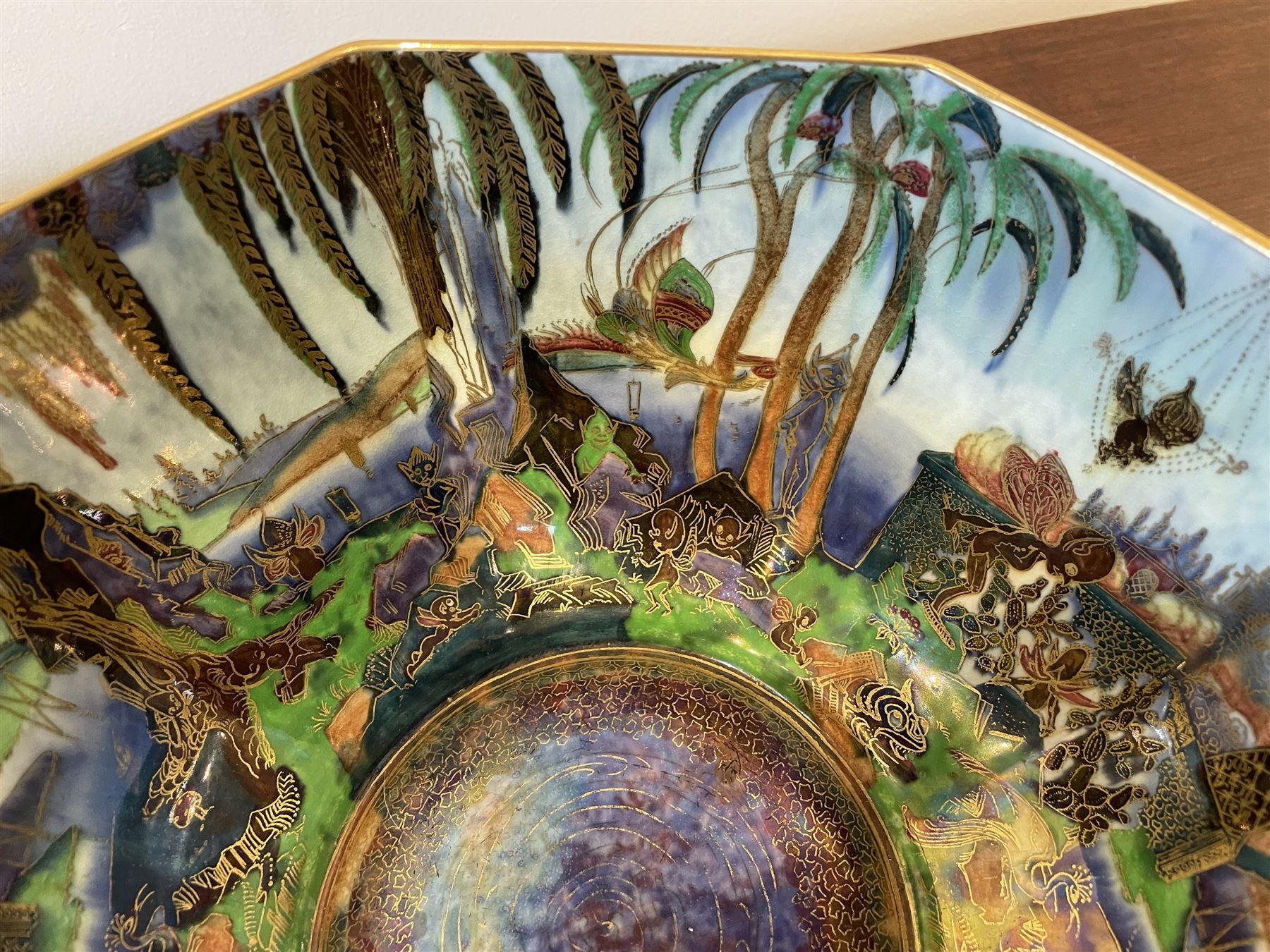 Early 20th century Wedgwood Fairland lustre bowl, circa 1920, of octagonal form, designed by Daisy Makeig-Jones, the exterior decorated in the Castle on the Road pattern, the interior decorated in the Fairy in a Cage pattern, pattern no Z5125, with printed marks beneath, H11cm D22.5cm
