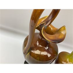 Linthorpe pottery vase with crimped rim and ovoid body, Linthorpe jug with high loop handle and crimped spout, a pair of candlesticks with a green, brown glaze and other similar pottery 