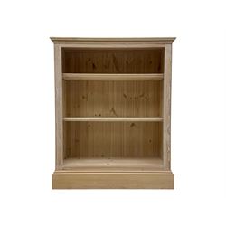 Contemporary light pine open bookcase, rectangular top with stepped moulded edge above a b...