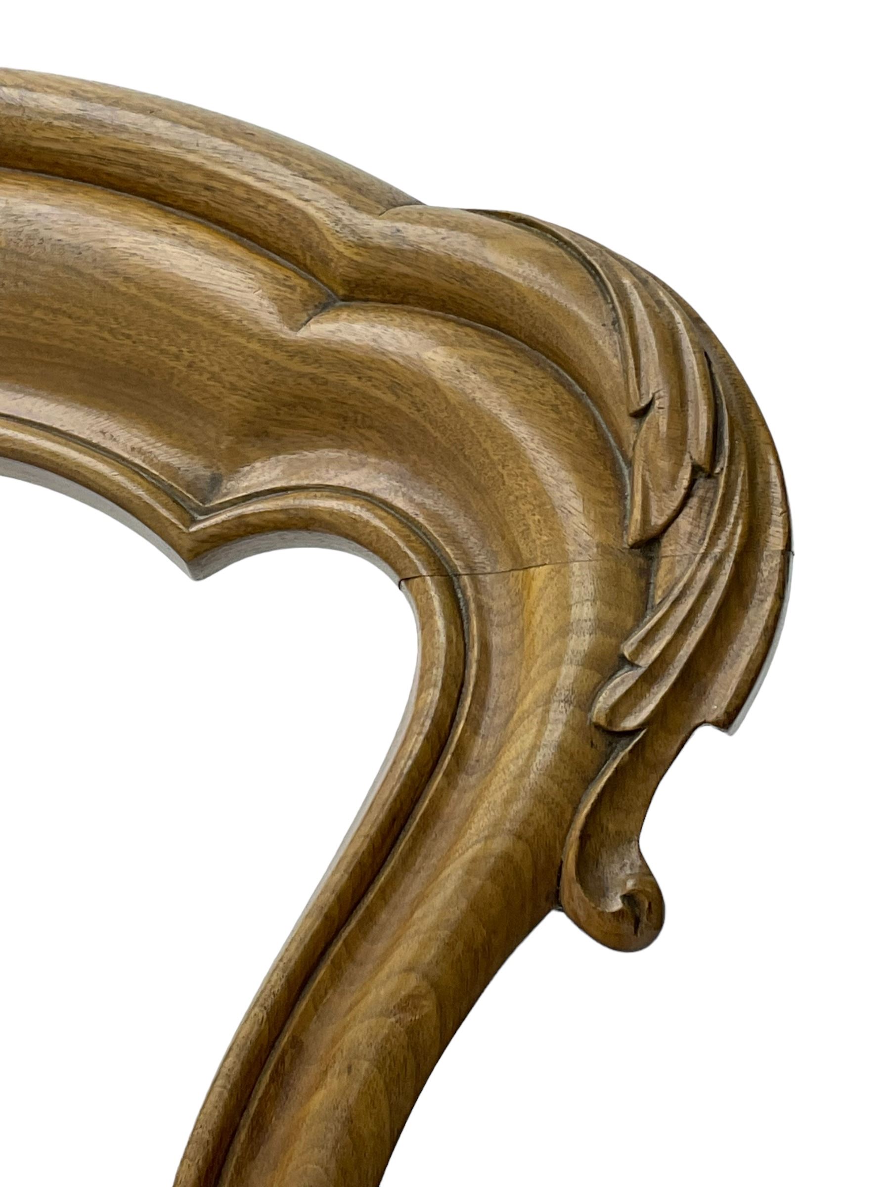 Pair of Victorian walnut side chairs, shaped cresting rail carved with acanthus leaves, overstuffed upholstered seats with stud band, on cabriole supports with scroll carved terminals