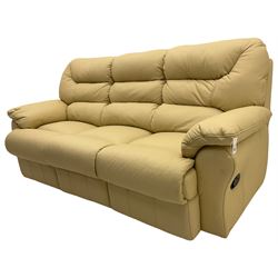 Three seat sofa upholstered in cream leather with end recliners