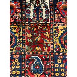 Large Persian garden rug, multiple rectangular panels decorated with stylised plants, Boteh and tree of life motifs, the outer guarded border with floral design 