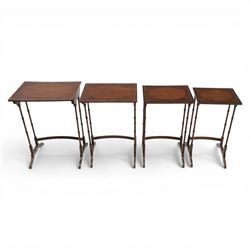 20th century mahogany quartetto nest of tables, the rectangular tops with oval inlay, upon turned knopped supports, united by a curved stretcher, raised upon outswept feet