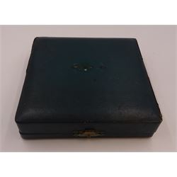 Set of four Edwardian silver open salts, of circular form, each with later personal engraving to scalloped rim and upon three pad feet, together with four matching silver salt spoons, hallmarked James Deakin & Sons, Sheffield 1909, in velvet and silk lined fitted case     