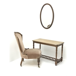  Victorian style mahogany framed nursing chair, upholstered in a deep buttoned fabric, turned supports (W57cm) a walnut stretcher table and an oval mirror (3)  