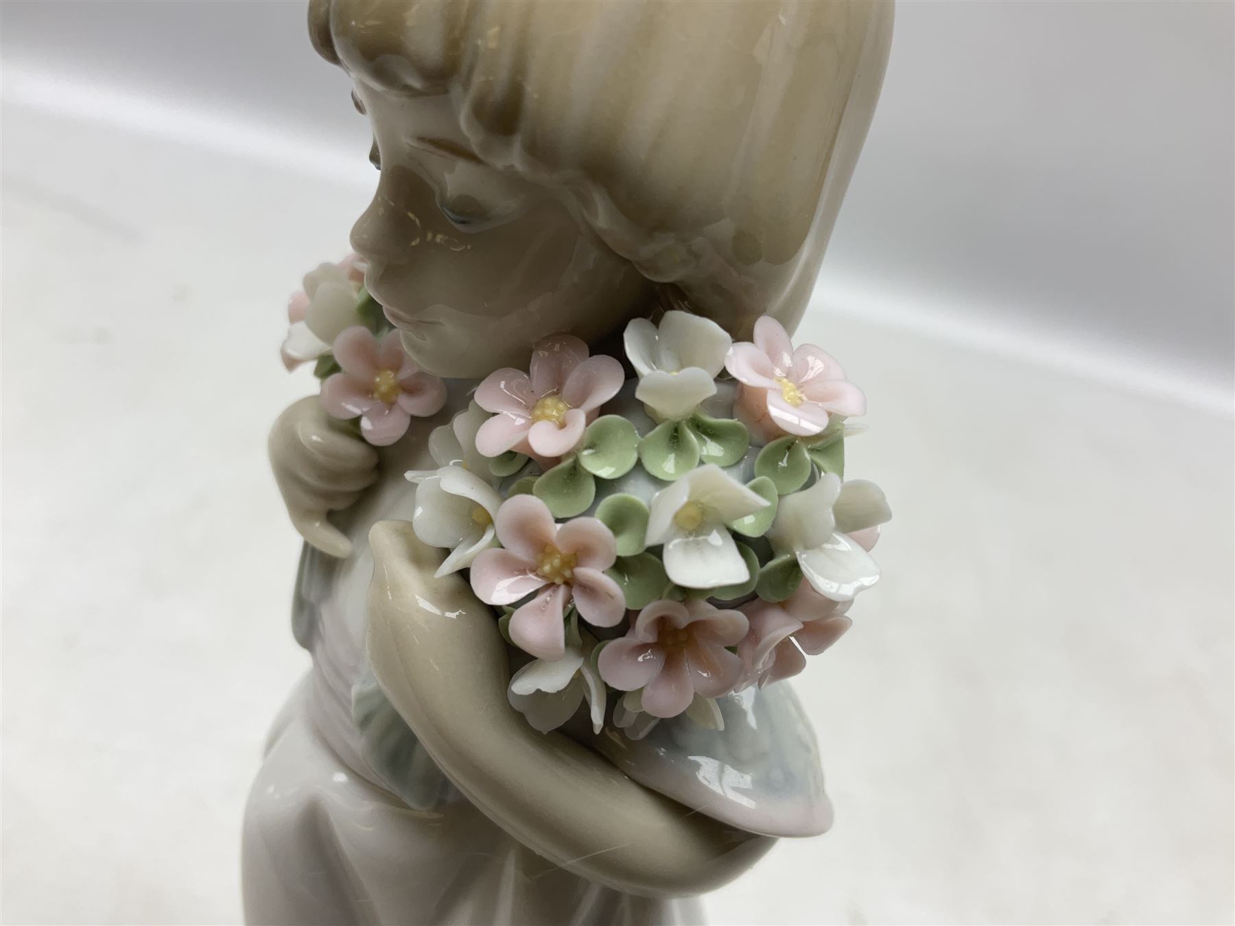 Three Lladro figures comprising, Pocket Full of Wishes no 7650, School Days no 7604 and Spring Bouquets no 7603, all with original boxes, largest example H26cm  