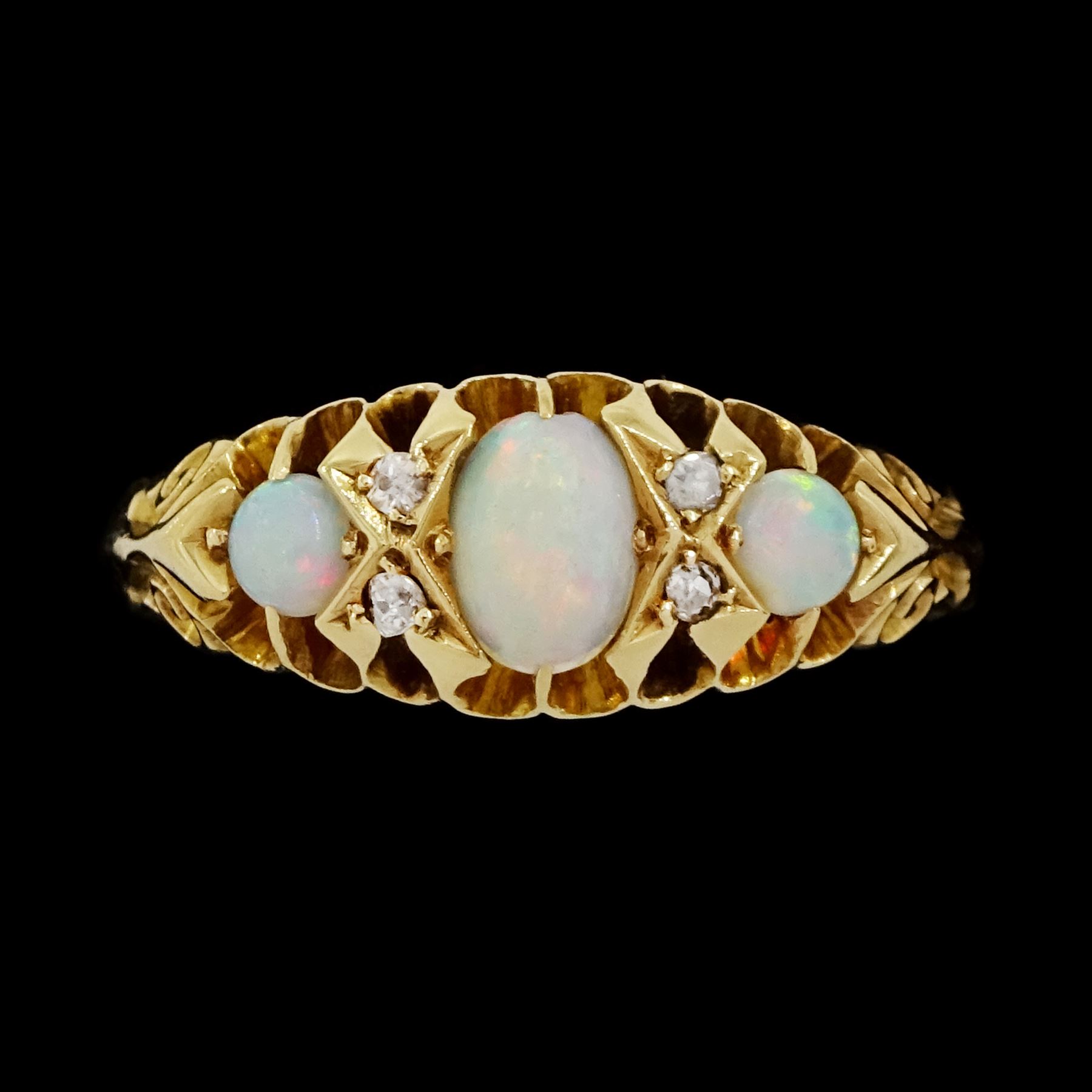 Edwardian 18ct gold opal and diamond ring, three cabochon cut opals, the principal stone with two round cut diamonds set either side, Birmingham 1910