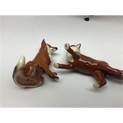 Beswick hunting group, comprising huntswoman on dappled grey horse no 1730, huntsman on bay horse no 1501, two fox figures no 1440 and 1748, and four fox hounds, all with printed marks beneath (8)