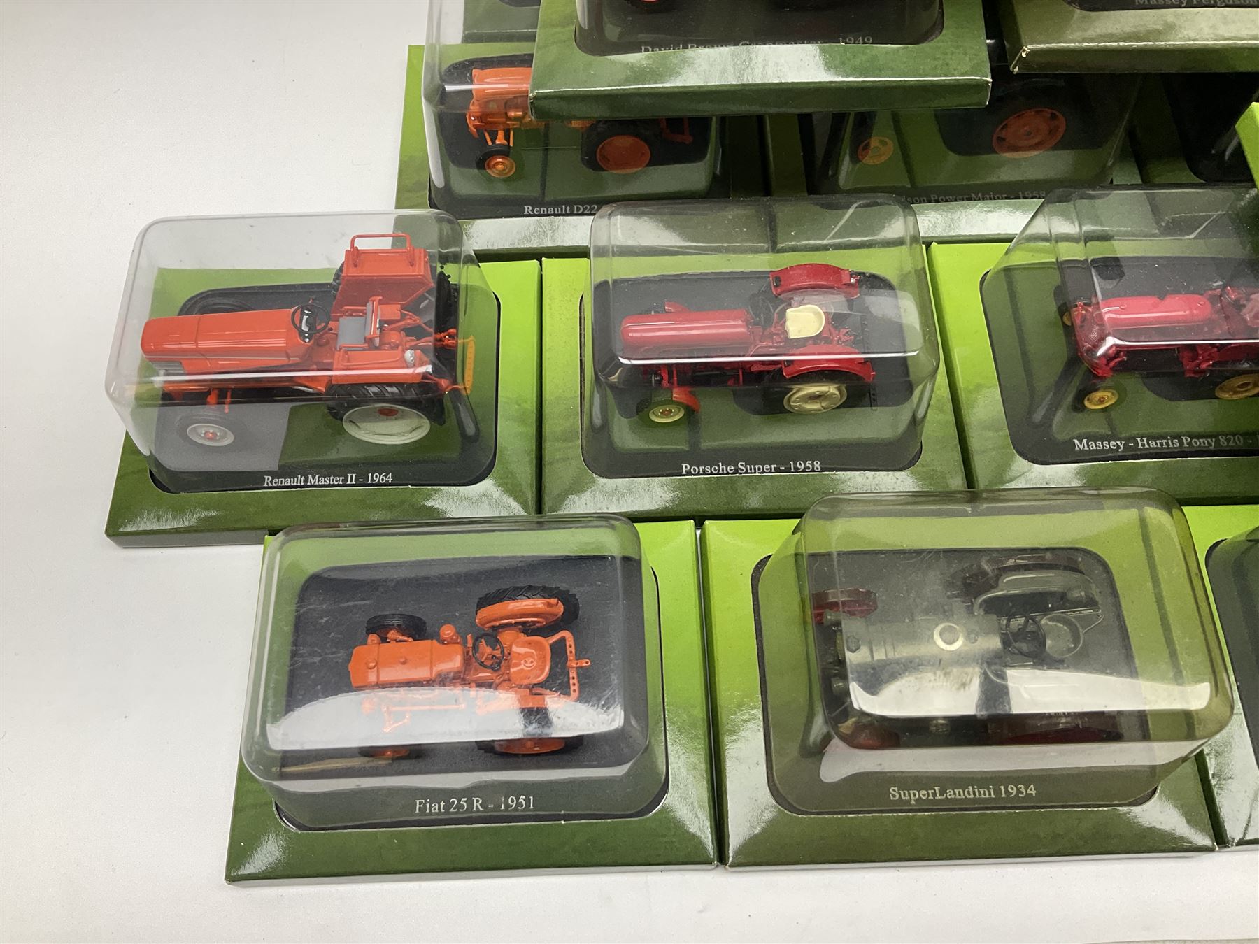 Eighteen issues of Tractors and The World of Farming magazine, together with sixty diecast tractors, all in original packaging, in three boxes 