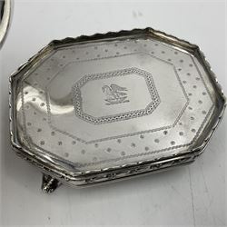 Victorian silver four piece tea service, comprising teapot, teapot stand, twin handled open sucrier and milk jug, each of octagonal form with foliate bud border and engraved decoration including crest to canted panels, and vacant panels, the teapot with ivory finial to the hinged cover and later wooden handle, hallmarked Edward Barnard & Sons Ltd, London1896, teapot including finial H15cm, milk jug including handle H16cm, teapot stand W11.5cm

This item has been registered for sale under Section 10 of the APHA Ivory Act