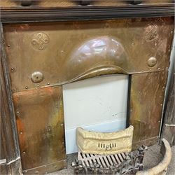 Late 19th/early 20th century fireplace, oak surround with projecting dentil cornice over bevelled mirror and shelf, with copper inset decorated with Heraldic knot motifs and rivets, together with various fire accessories 