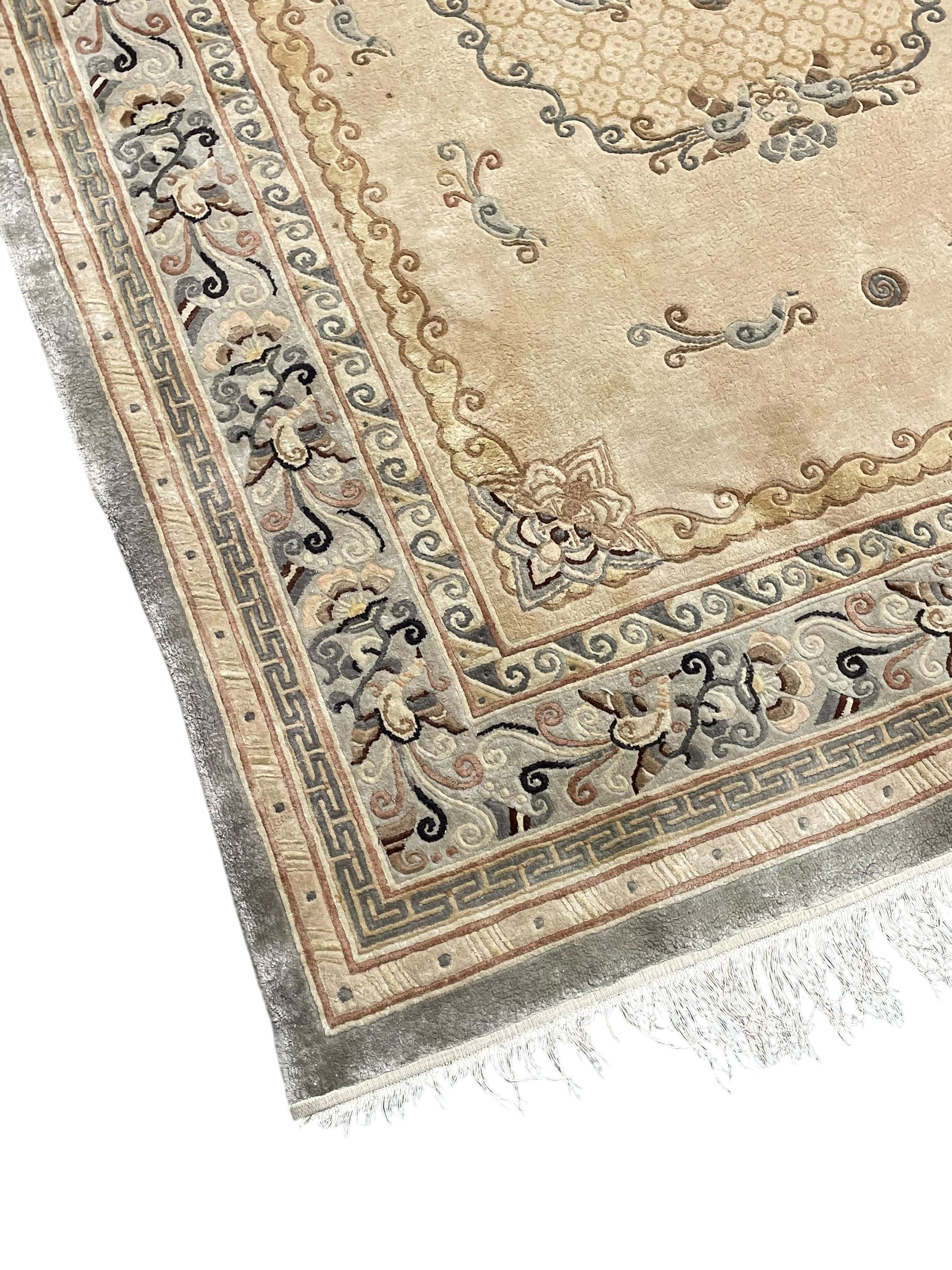 Chinese washed woollen camel ground rug, circular medallion surrounded by scrolls, the border decorated with birds and trailing floral decoration (248cm x 155cm); Chinese washed woollen pale green ground rug (125cm x 69cm); Persian design rug (186cm x 121cm) (3)